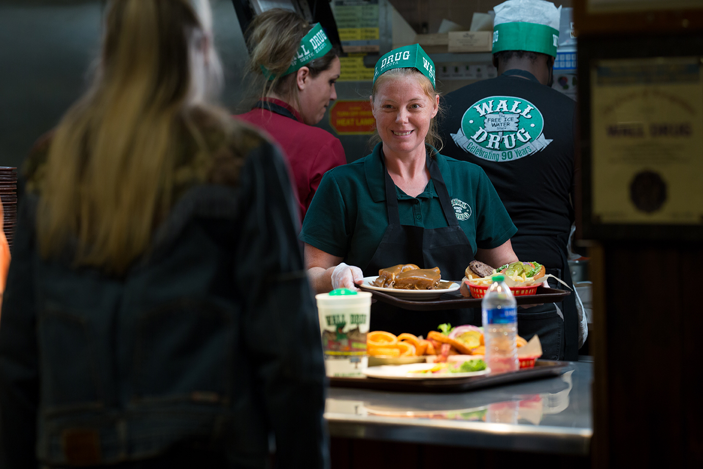 wall drug eployee happily serving a customer